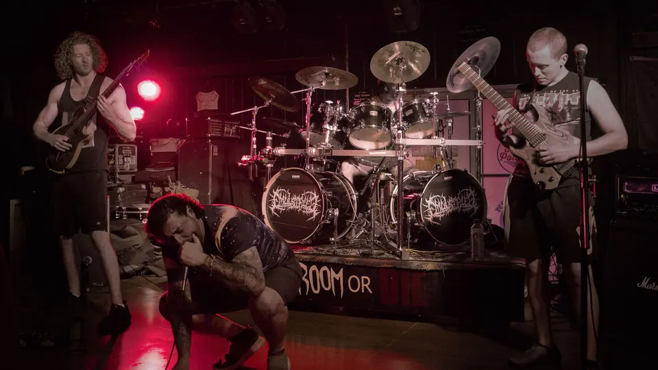 Emulsified playing the Doom Room, the drum kit lit red from behind