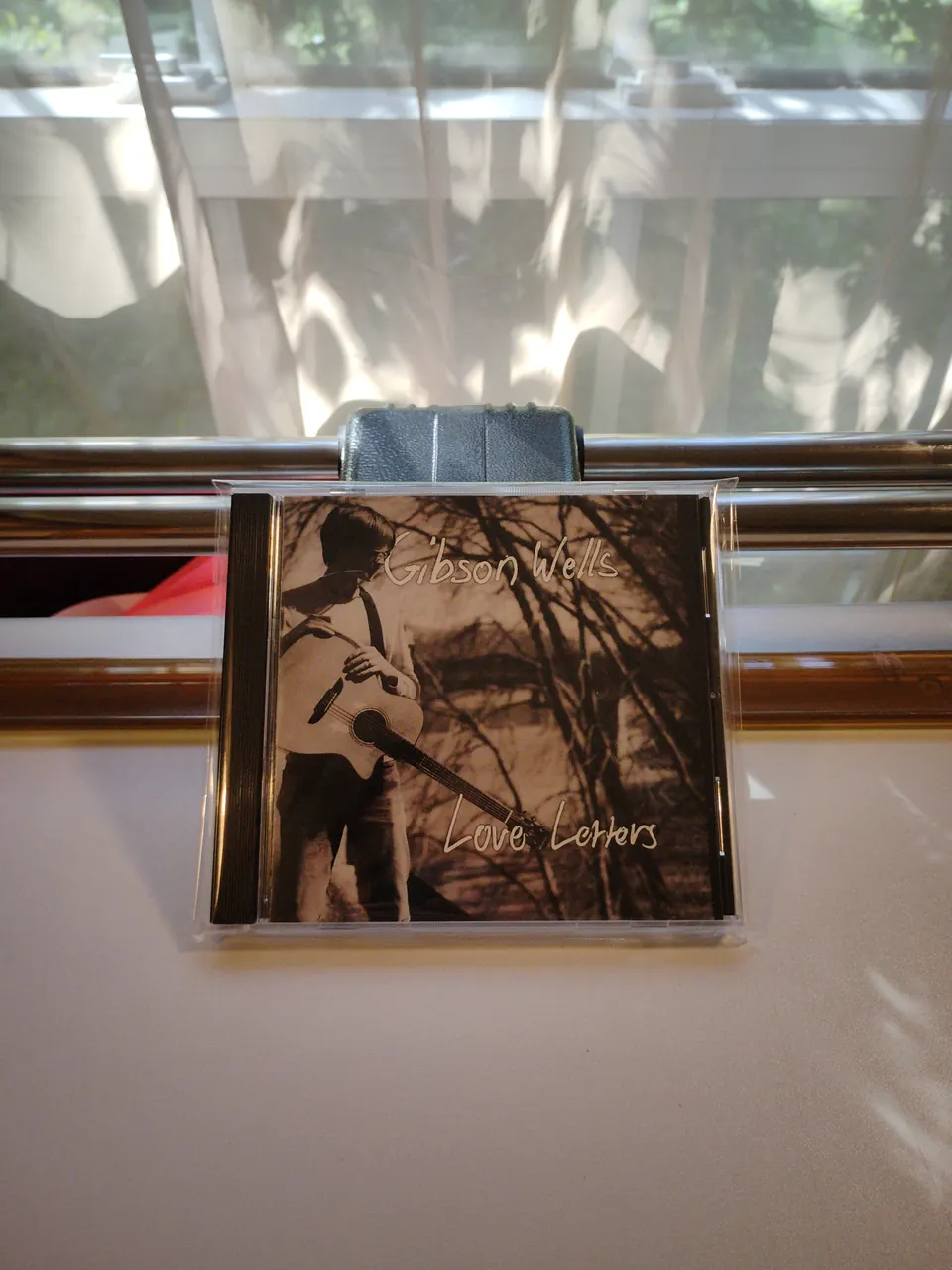 The CD Love Letters by Gibson Wells, standing in a window