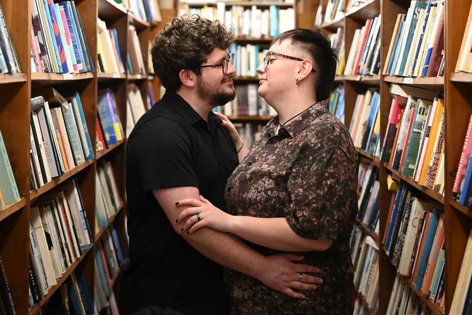 Aaron and Ethan laughing between bookshelves