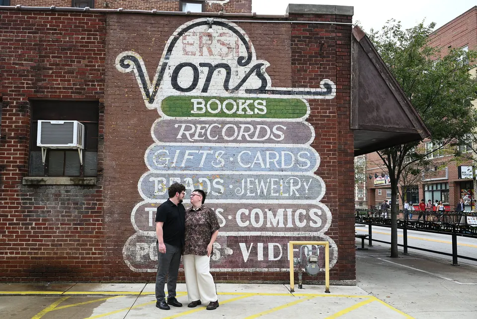 Aaron and Ethan in front of the painted Von’s Books sign