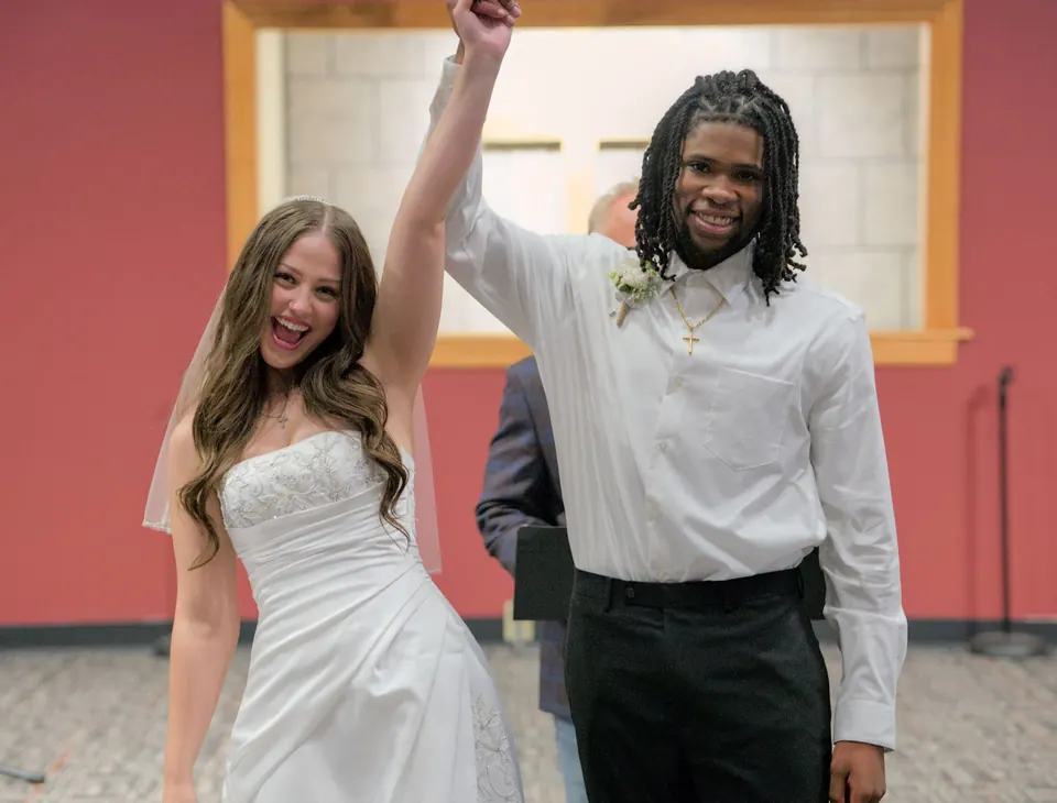 Kassie and Noah celebrating at the front of the church after their vows