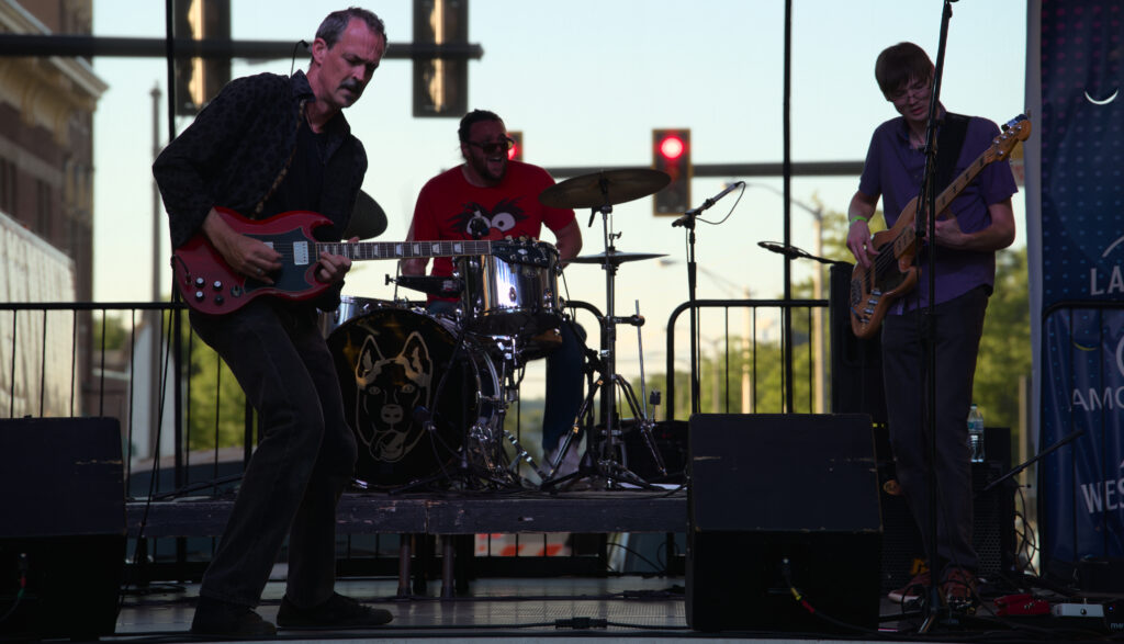 Jason Wells Band playing an outdoor stage at dusk